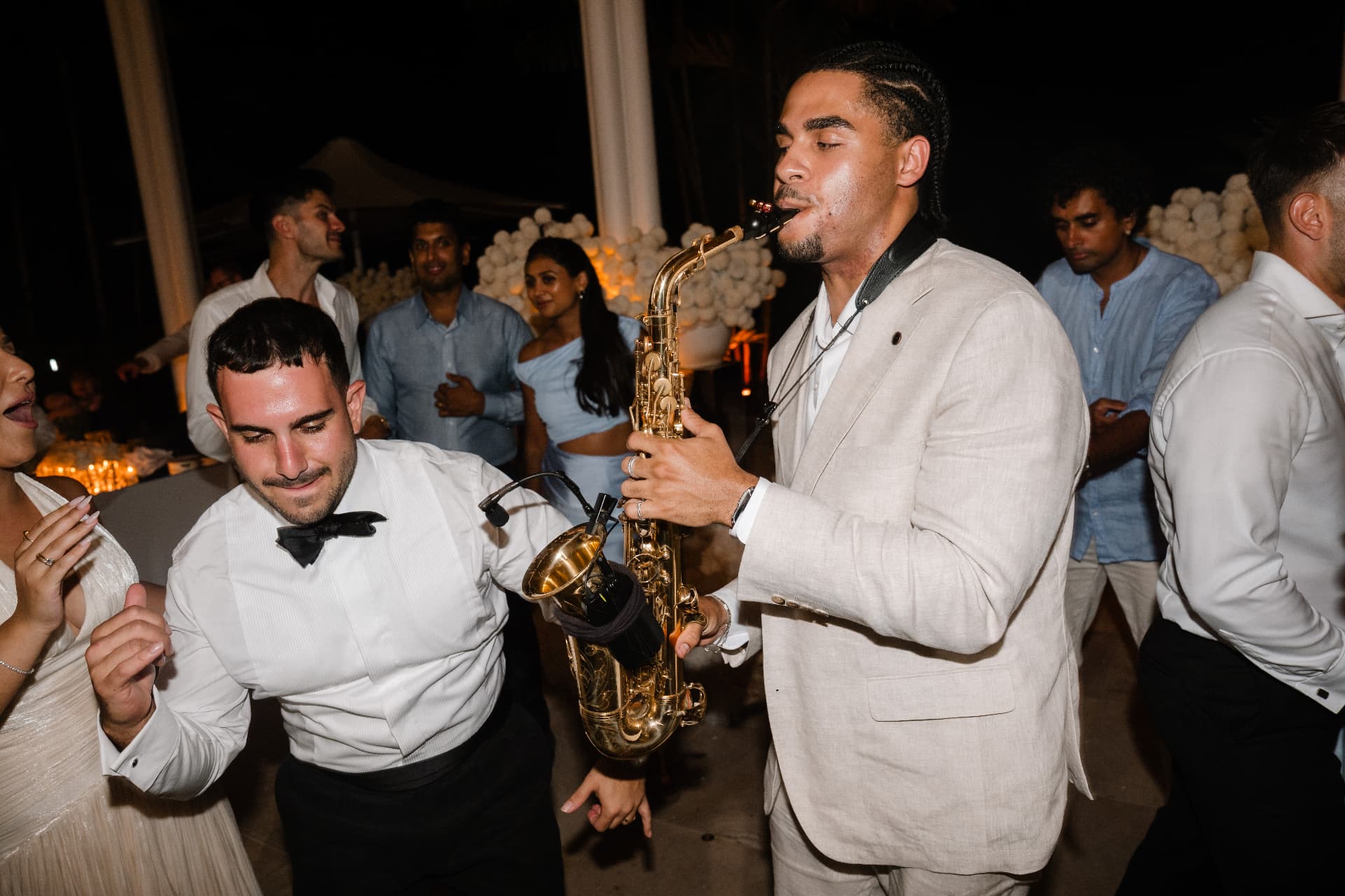 Saxophone in the middle of the crowd at a wedding