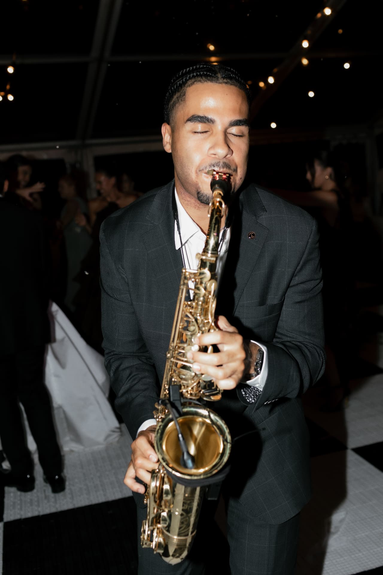 Playing saxophone on the dance floor at an evening wedding