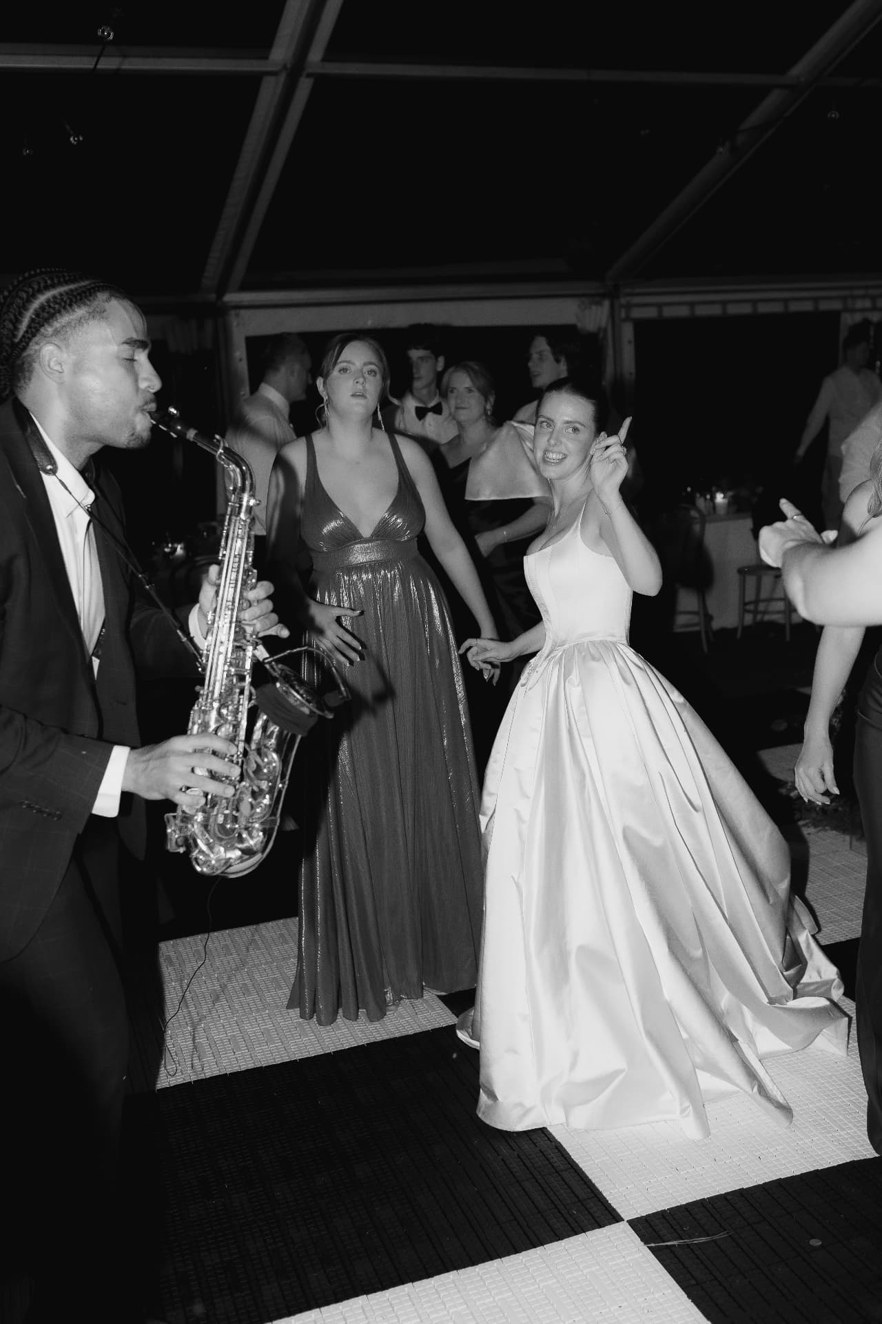Bride dancing beside the saxophone
